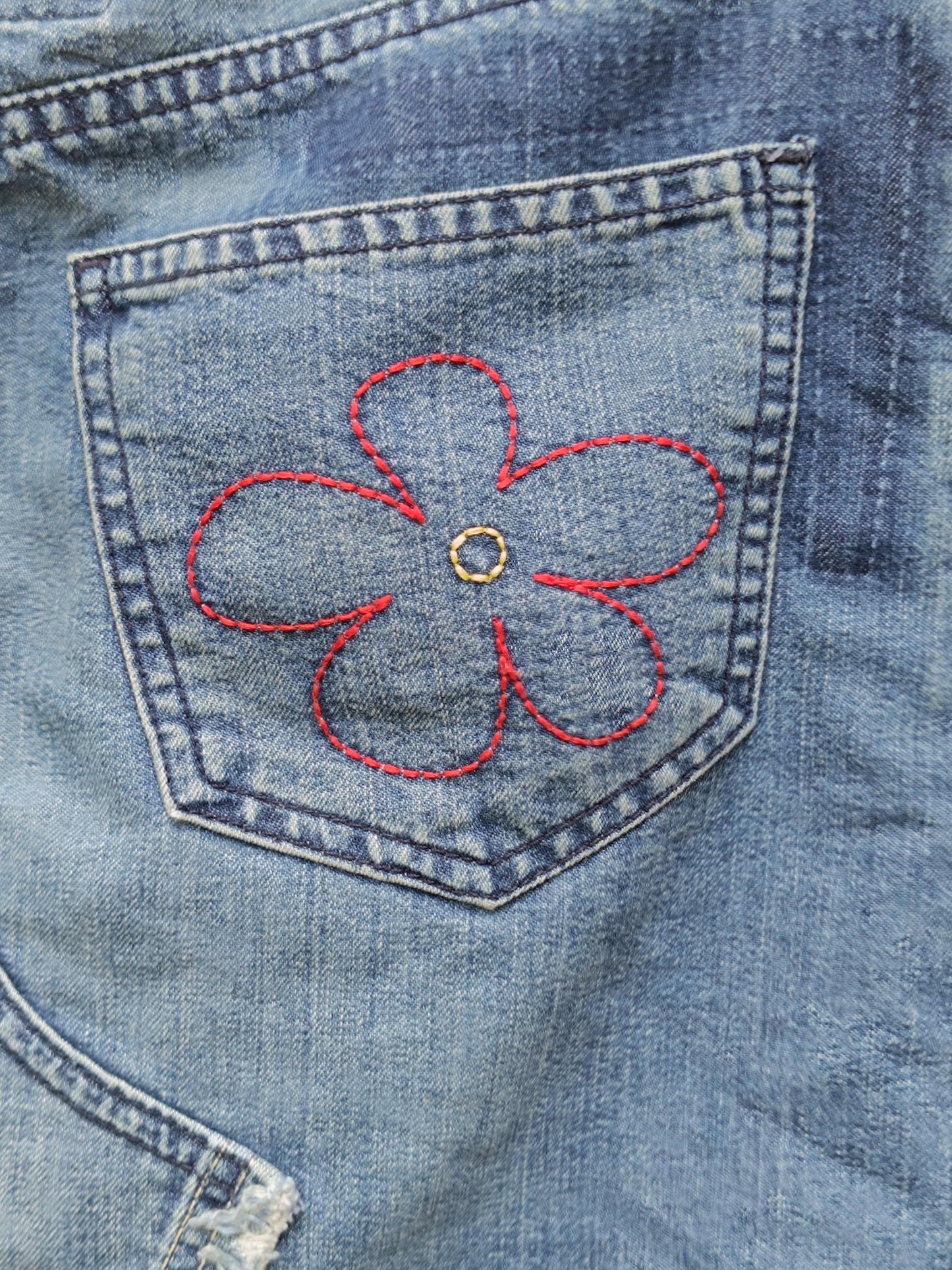 A detailed view of the floral embroidered details at the back of a blue y2k Esprit Maxi Skirt