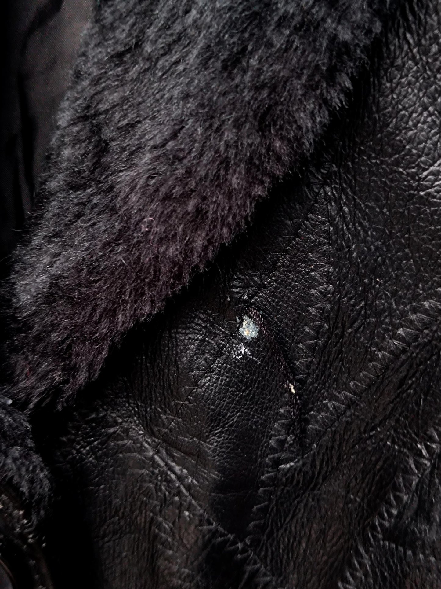 Detail shot of a flaw on the vintage patchwork black leather jacket by Anne De Lancay