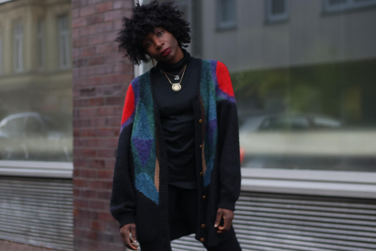 Cozy yet bold, this vintage knit cardigan blends vibrant hues with a slouchy silhouette, channeling an artsy, androgynous aesthetic.