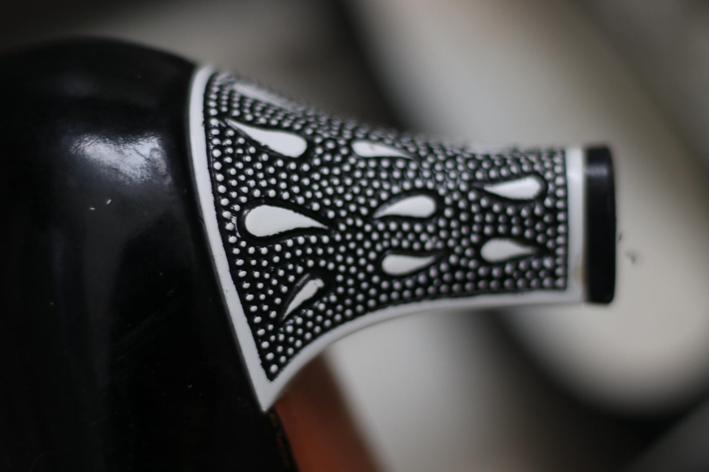 Detail shot of the statement black and white print heels of a retro designer pumps by Bruno Magli photographed against a minimalist background.