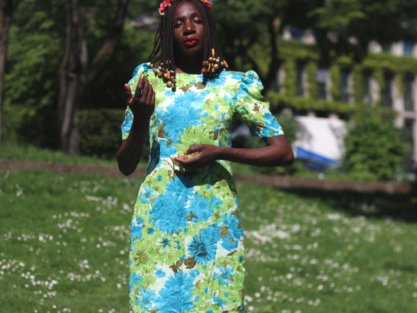 A one-of-a-kind handmade flower power dress with puff sleeves, showcased on a female model wearing a pink and red floral crown. The mod feminine dress is ideal for garden parties, festivals, or retro-inspired outfits.