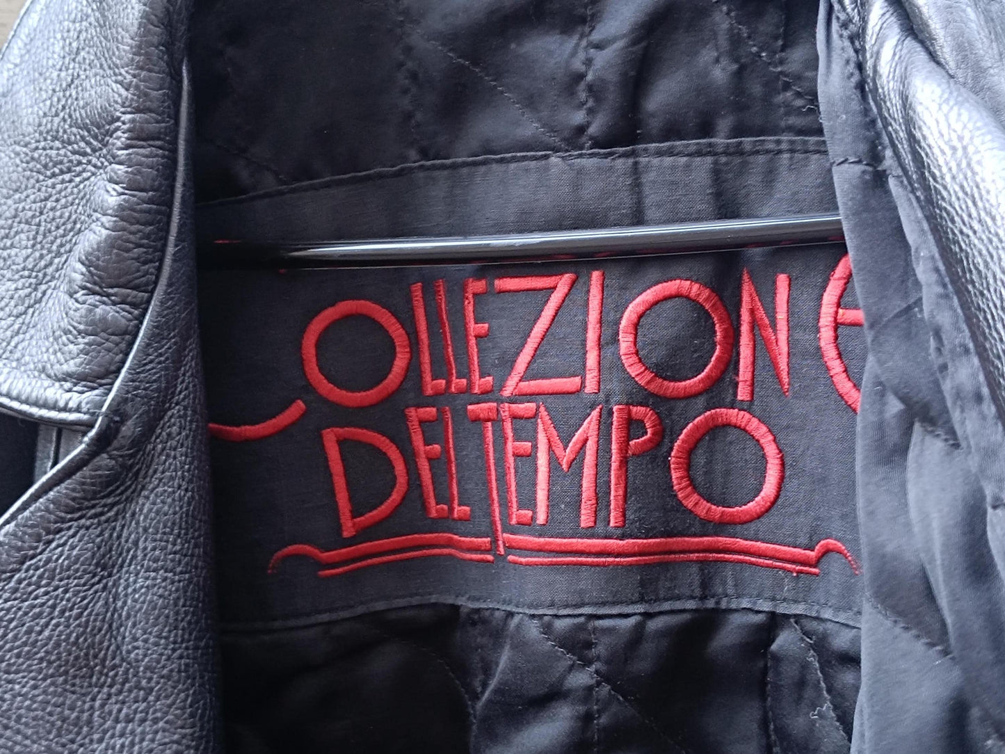 Red stitched brand logo on the quilted black lining of retro 80as black motorcycle jacket" The text reads "