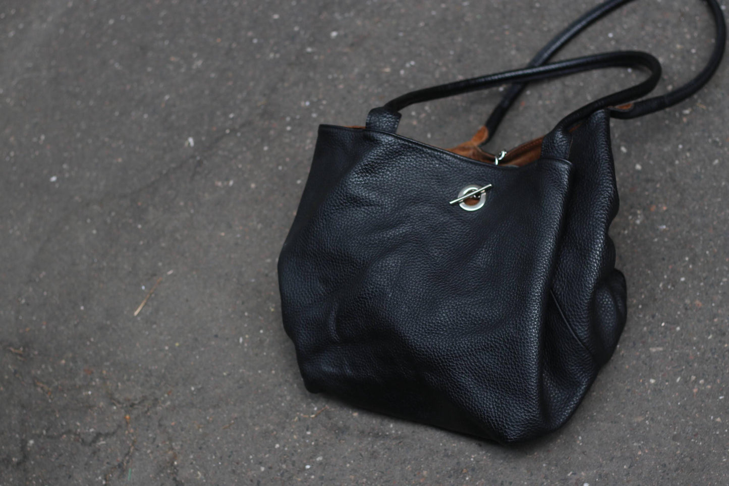 Vintage Oversized black genuine leather minimalist tote bag with an unstructured shape and contrasting brown inside.