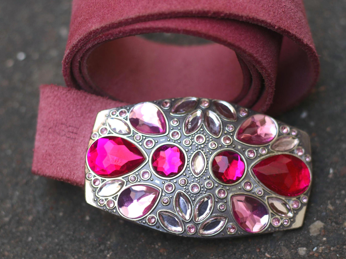 Bold vintage Esprit belt with pink crystals and Italian suede leather photographed on a gray asphalt background