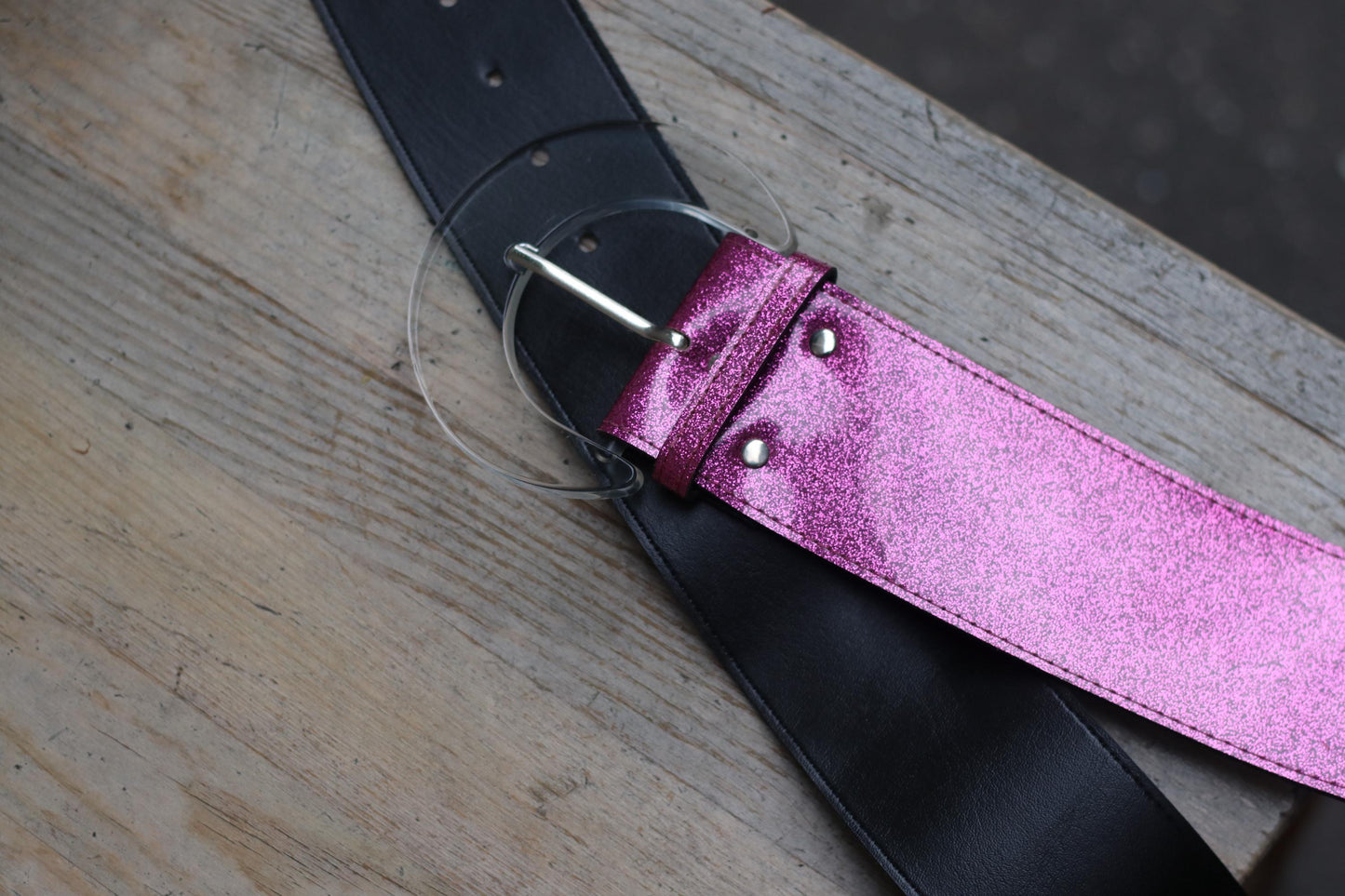Statement fashion belt with magenta sparkle and bold half-moon clasp