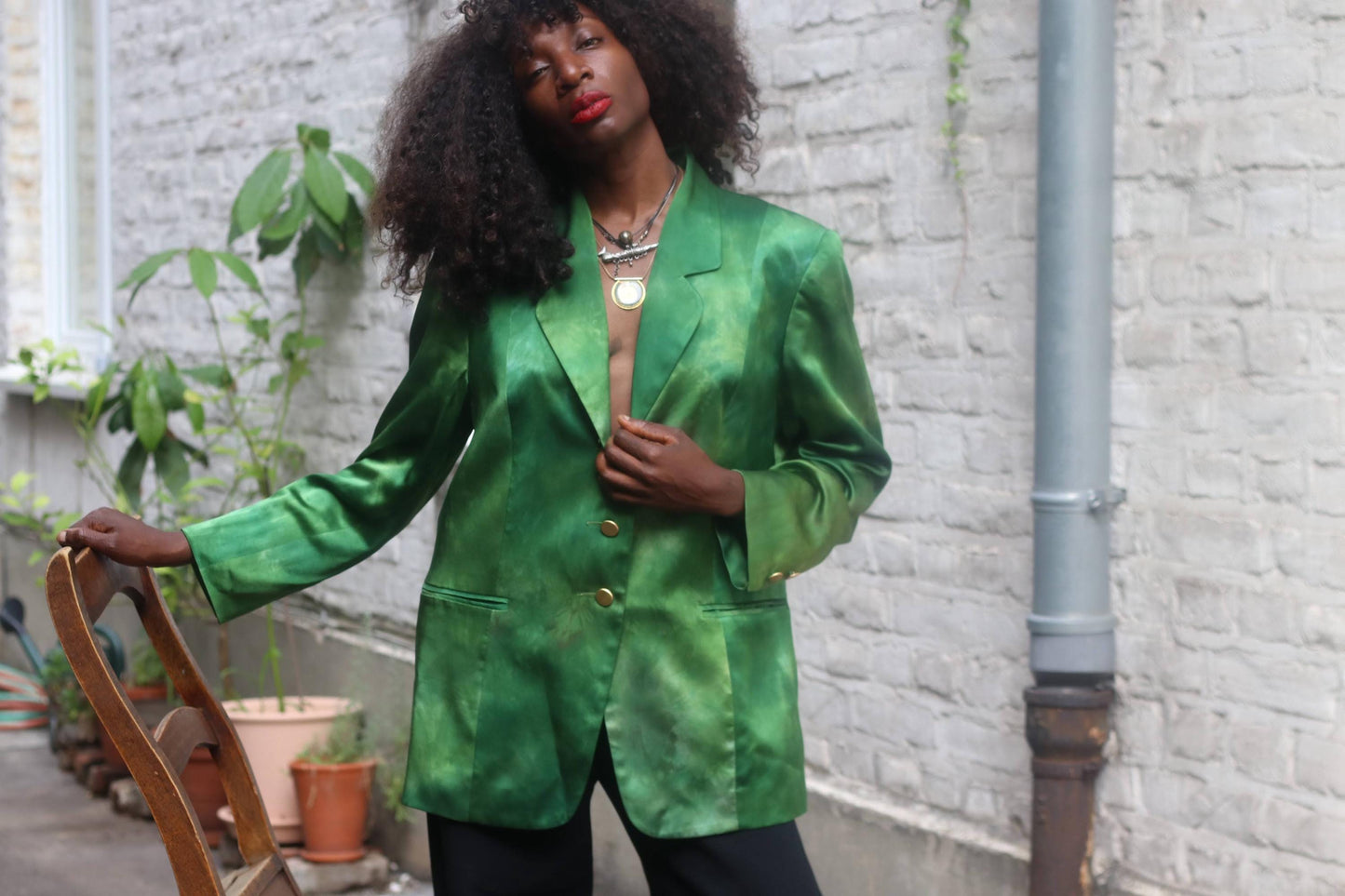 Model wearing vintage emerald green silk blazer outdoors