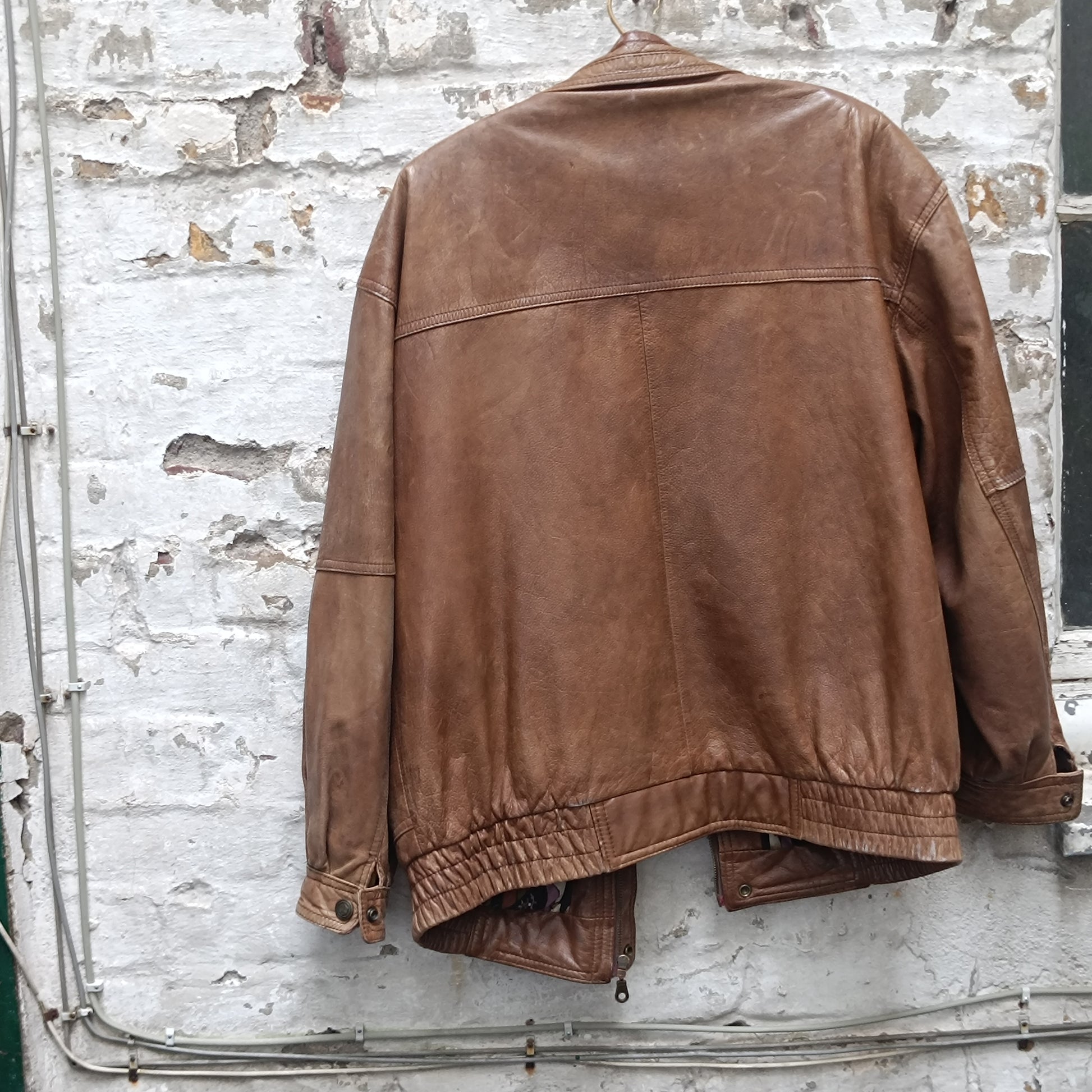 Vintage 1980s Brown Leather Bomber Jacket abstract patterned lining oversized M