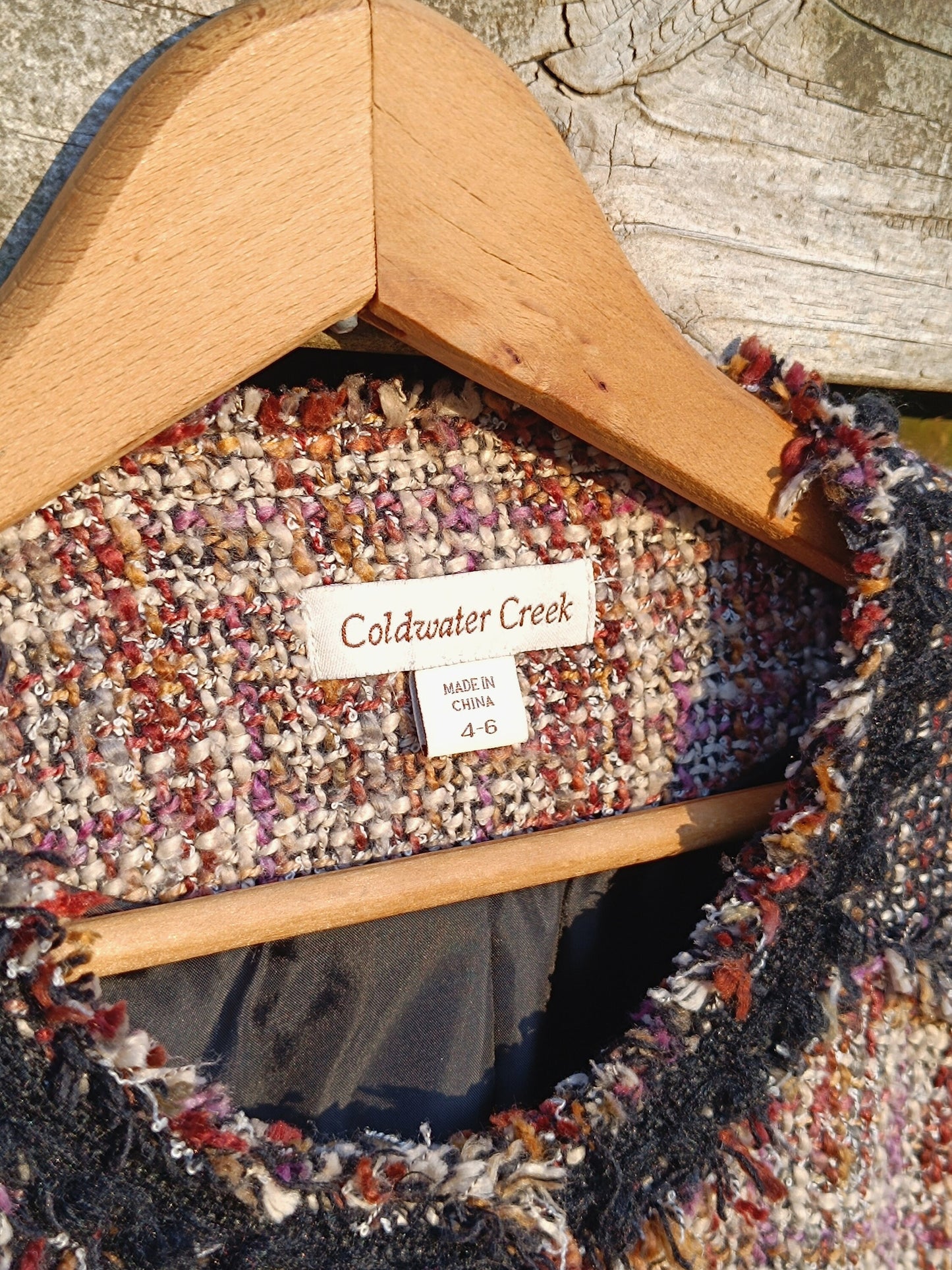 Close up of the brand tag of a Vintage 90s grey textured tweed blazer by Coldwater creek