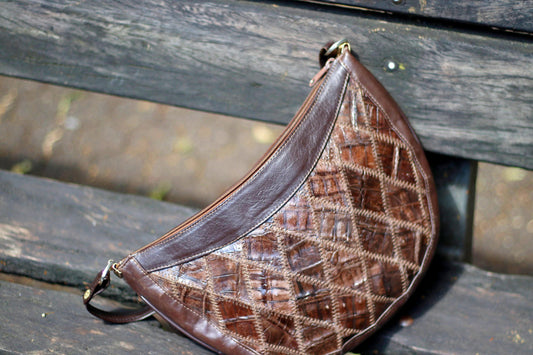 70s Handmade Leather bag for women photographed outdoors on a wooden dark brown bench