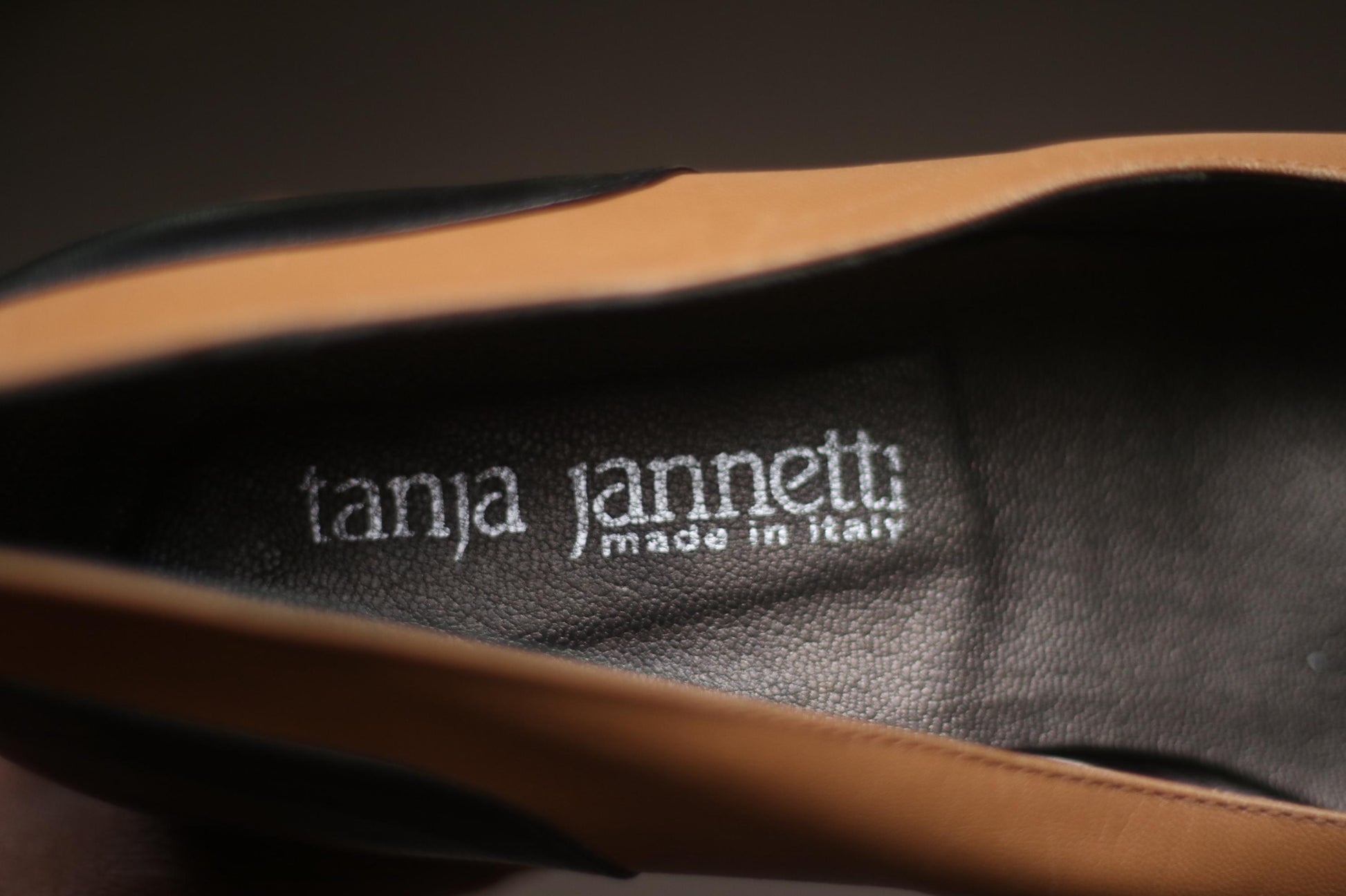 Close up of a pair of vintage two-tone high heels in brown and black The brand is Tanja Jannetti.