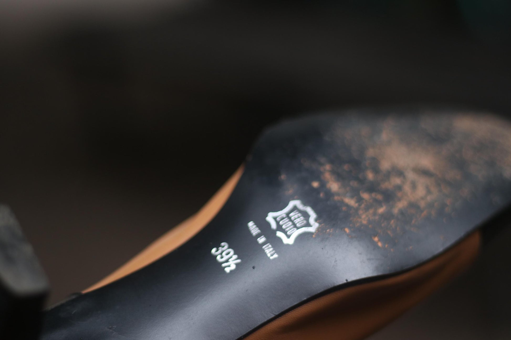 Close-up of a vintage shoe sole with text indicating size and &quot;Made in Italy&quot;.