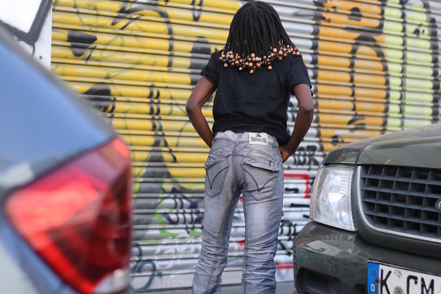 Detail shot of waistband and back features on silver biker jeans with a soft sheen and grunge-inspired fit.