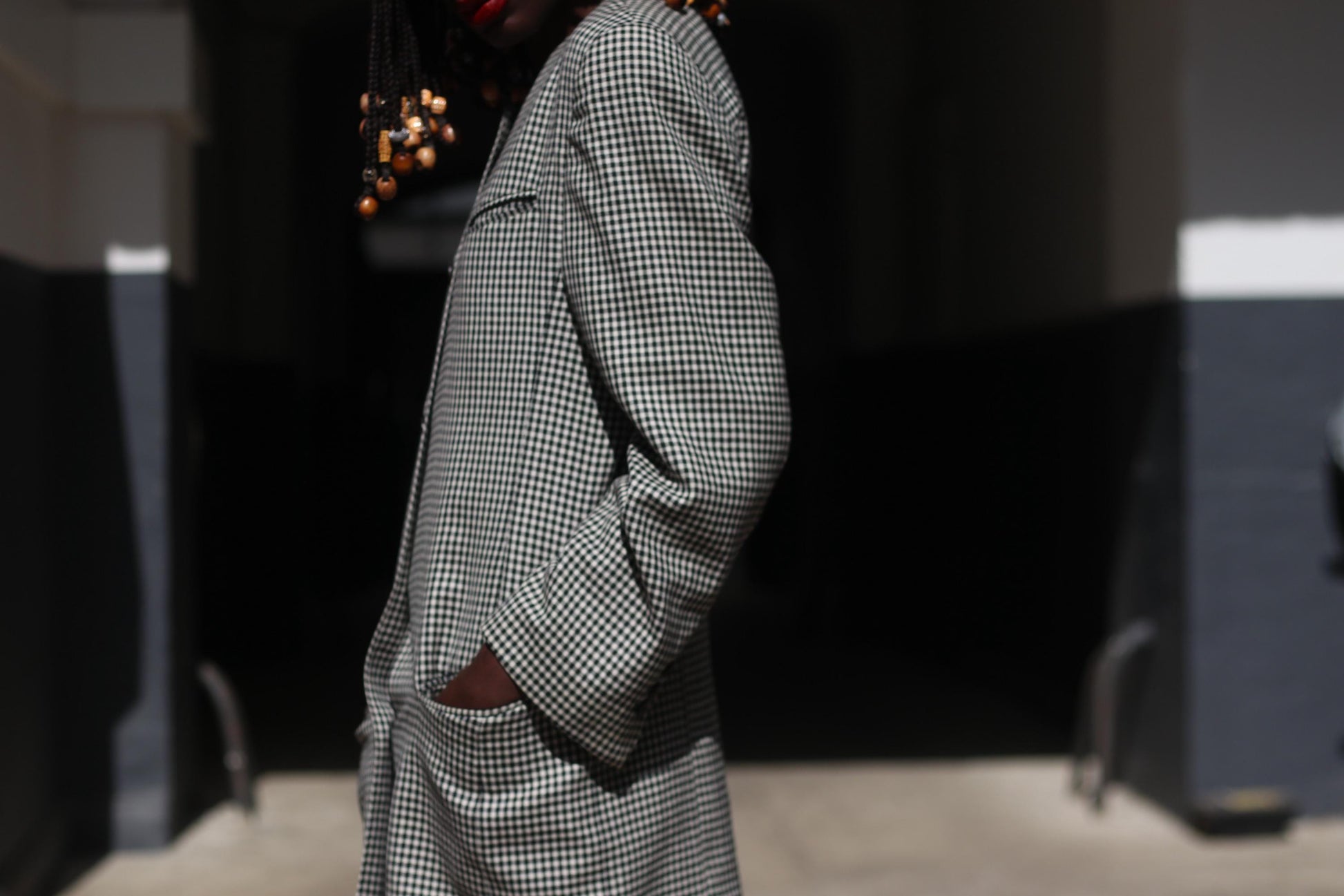 Close-up of a vintage 90s black and white gingham blazer on a female model emphasizing the texture and vintage craftsmanship