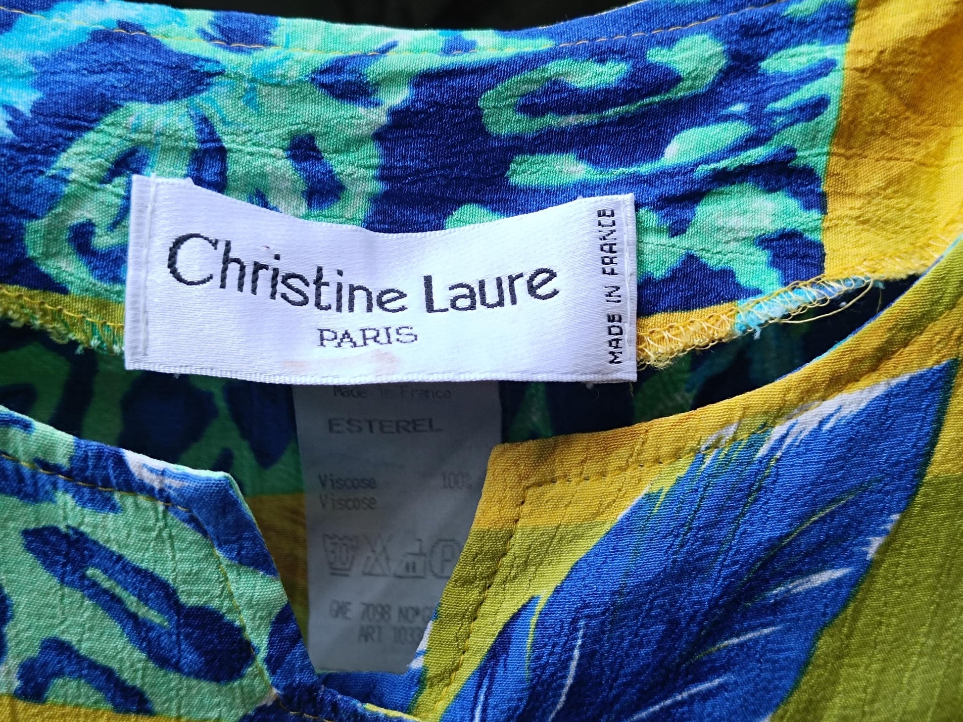 Close up of an image of a white brand tag that reads in black lettering: Christine Laure Paris